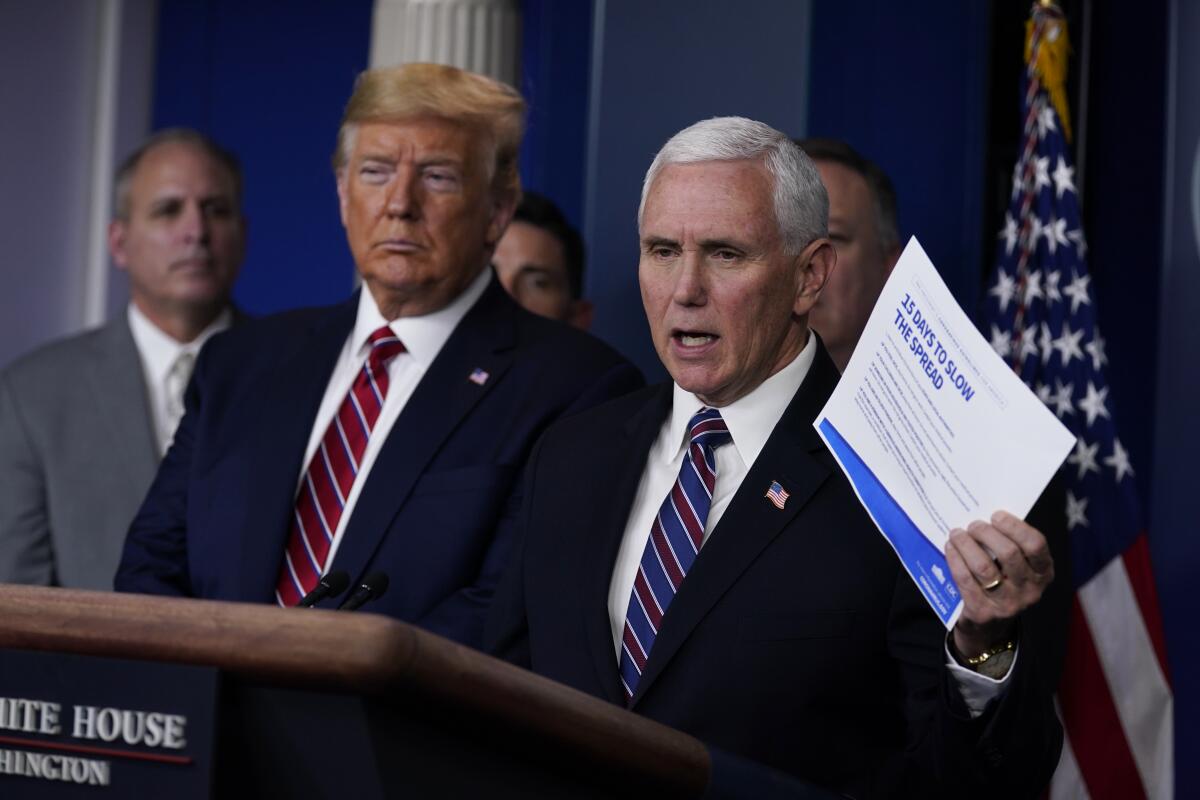 President Donald Trump listens as Vice President Mike Pence speaks at a coronavirus task force briefing in March.