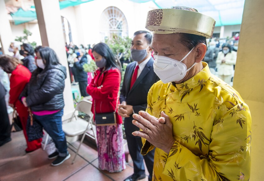 A parishioner prays during a mass at the Vietnamese Catholic Center in Santa Ana.
