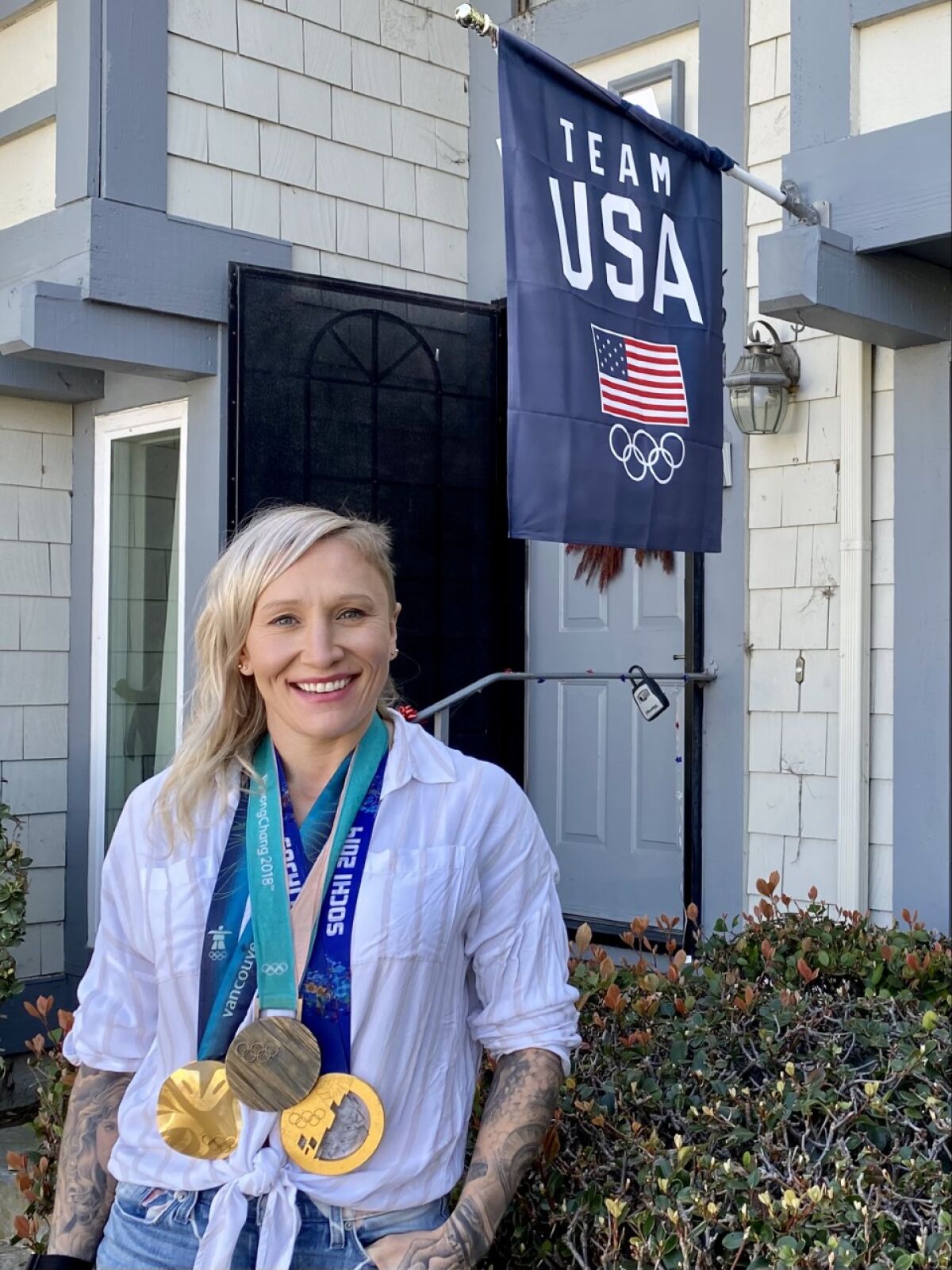 World bobsled champion Kaillie Humphries shows off some of her medals in front of her Carlsbad townhome.