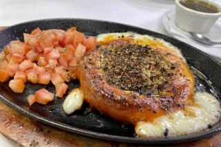 The provoleta served on a hot skillet at Mercado Buenos Aires in Van Nuys.