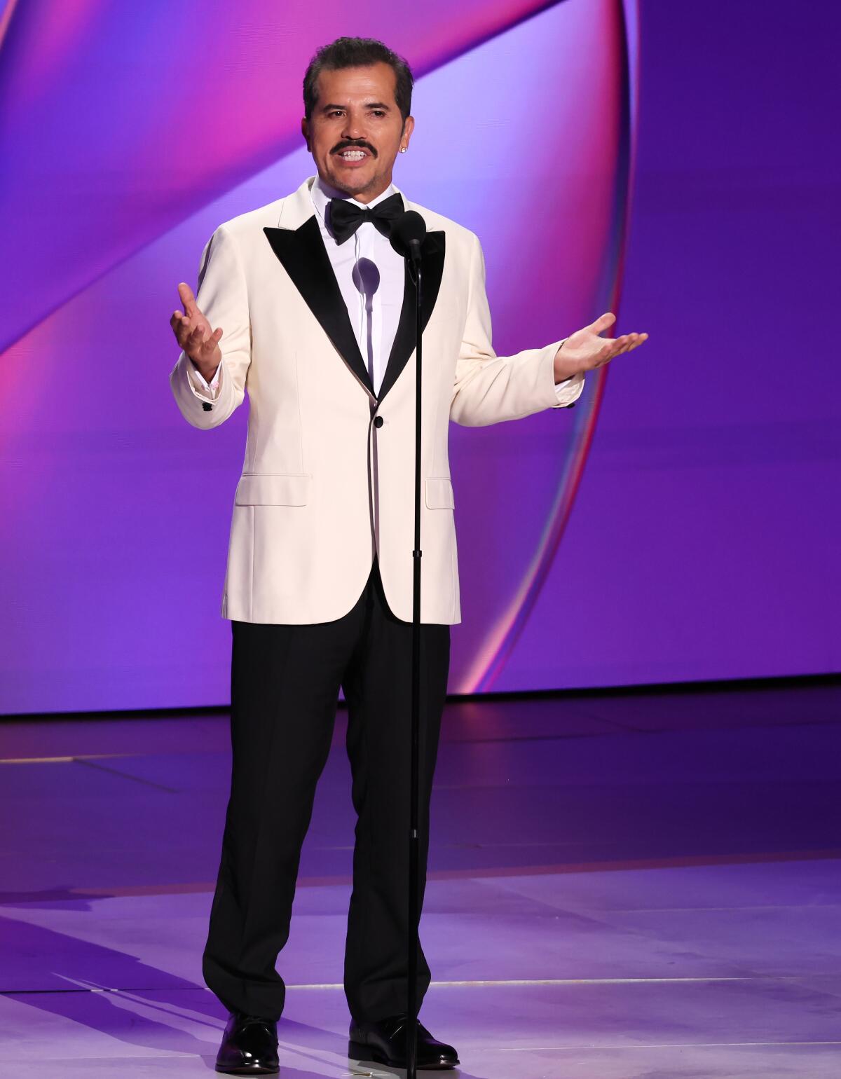 A man standing onstage and making a speech