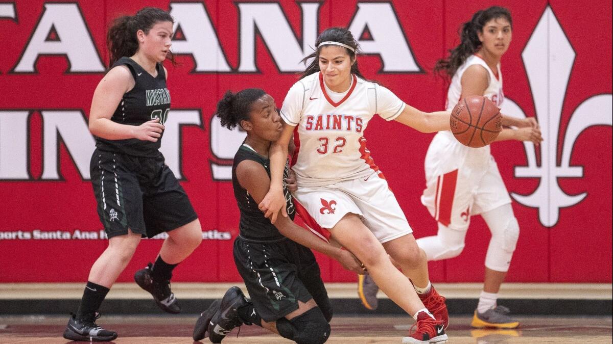 Costa Mesa High's Tarah Harmon attempts to steal the ball from Santa Ana's Elizabeth Zavala during an Orange Coast League game on Monday.