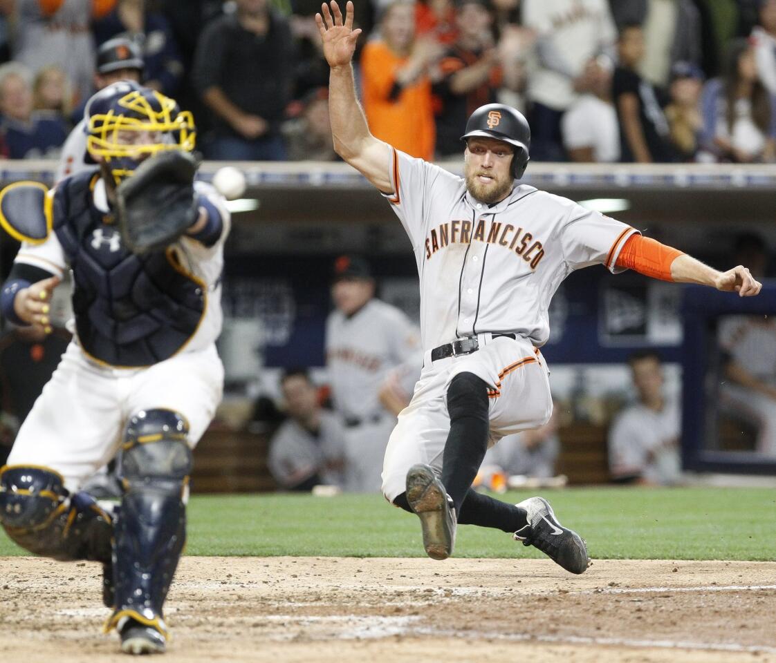 The Giants' Hunter Pence scores as the Padres' Derek Norris takes the throw in the eighth inning .