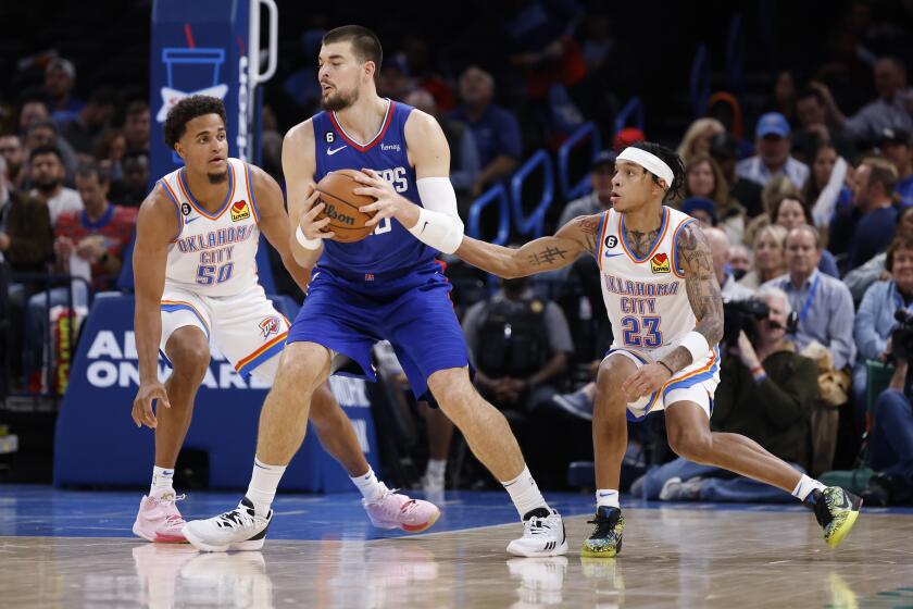 Los Angeles Clippers center Ivica Zubac (40) goes against Oklahoma City Thunder forward Jeremiah Robinson-Earl (50) and guard Tre Mann (23) during the first half of an NBA basketball game Tuesday, Oct. 25, 2022, in Oklahoma City. (AP Photo/Garett Fisbeck)