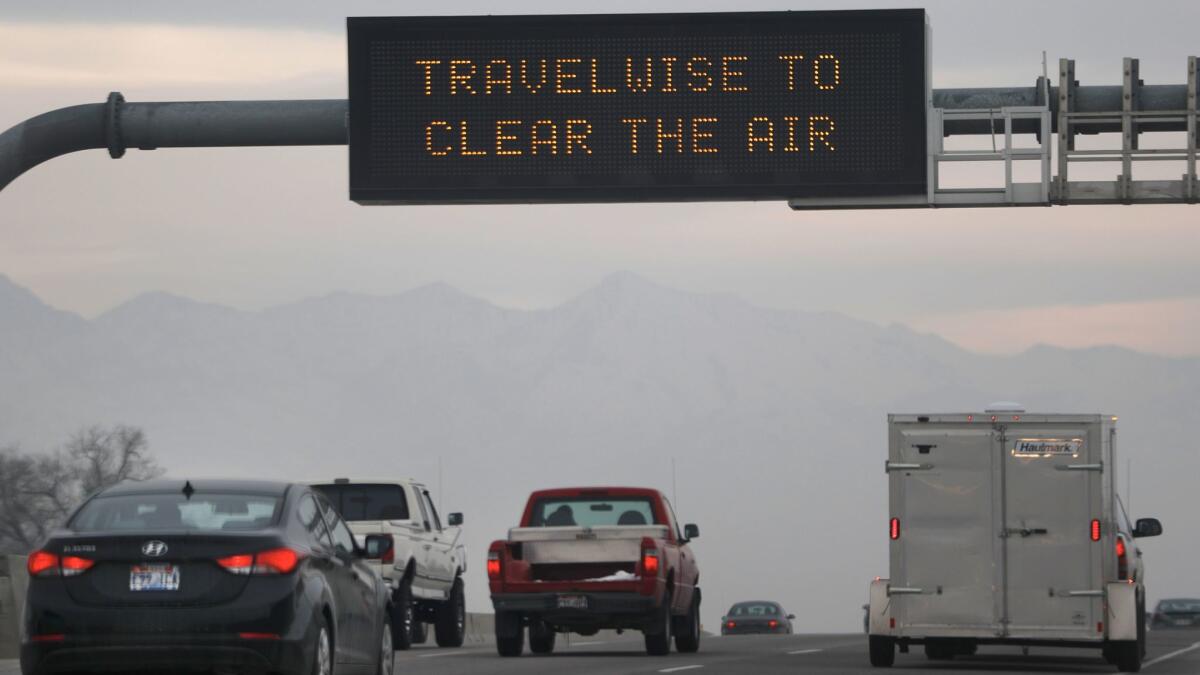 Thick smog caused by a temperature inversion looms on Interstate 15 near Salt Lake City.