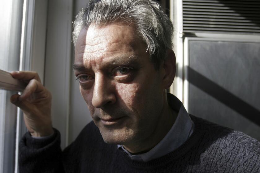 FILE - Writer Paul Auster poses at his home in the Brooklyn borough of New York, Jan. 19, 2006. Paul Auster, a prolific, prize-winning man of letters and filmmaker known for such inventive narratives and meta-narratives as “The New York Trilogy” and “4 3 2 1,” has died at age 77. (AP Photo/Bebeto Matthews, File)