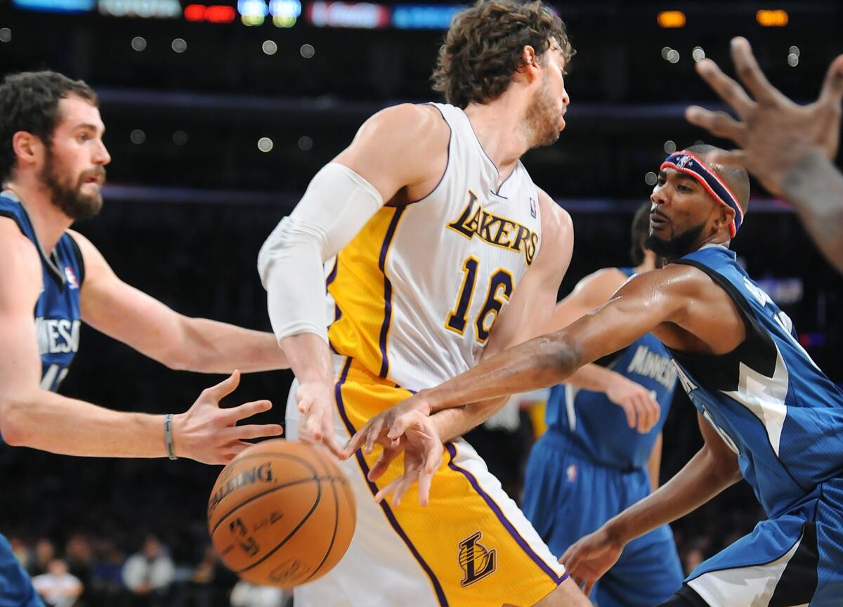 Minnesota Timberwolves guard Corey Brewer, right, knocks the ball away from Lakers forward Pau Gasol during the first half of the Lakers' 113-90 loss Sunday at Staples Center.