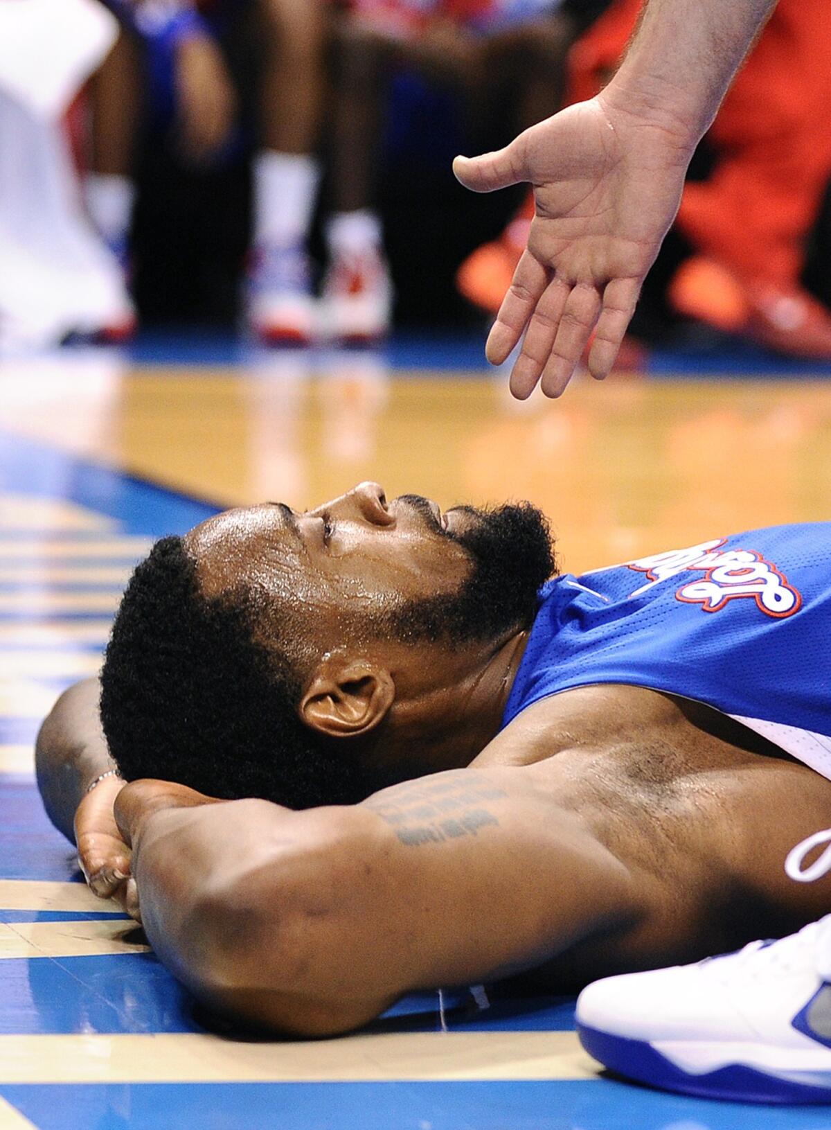 Clippers center DeAndre Jordan lies on the floor after picking up his fifth foul against the Oklahoma City Thunder on Tuesday night in Game 5 of the Western Conference semifinals.