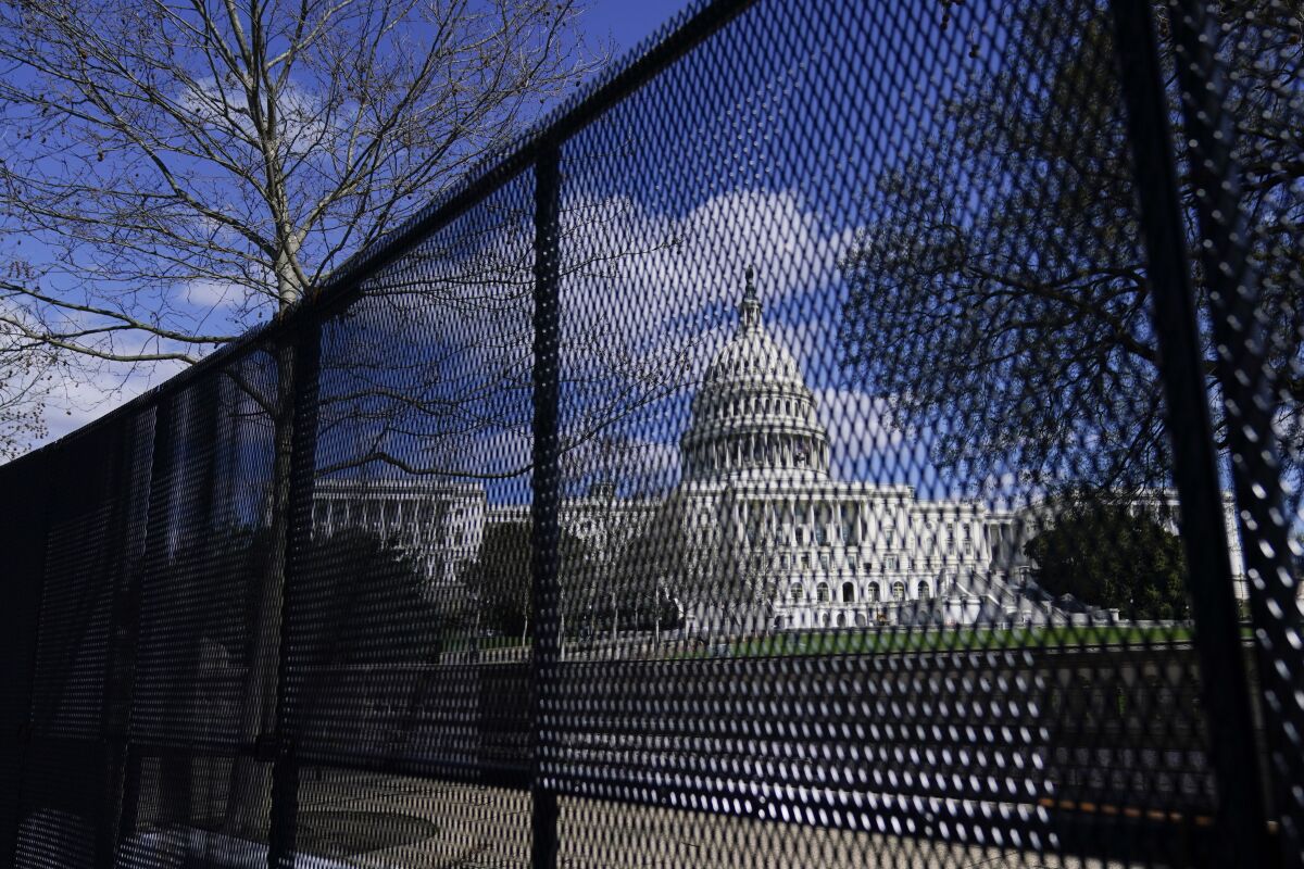 The U.S. Capitol is seen behind security fencing on Capitol Hill in Washington in April 2021. 
