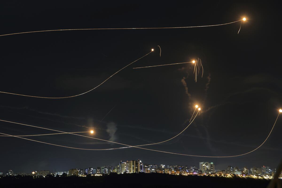 Interceptions of rockets showing in night sky 