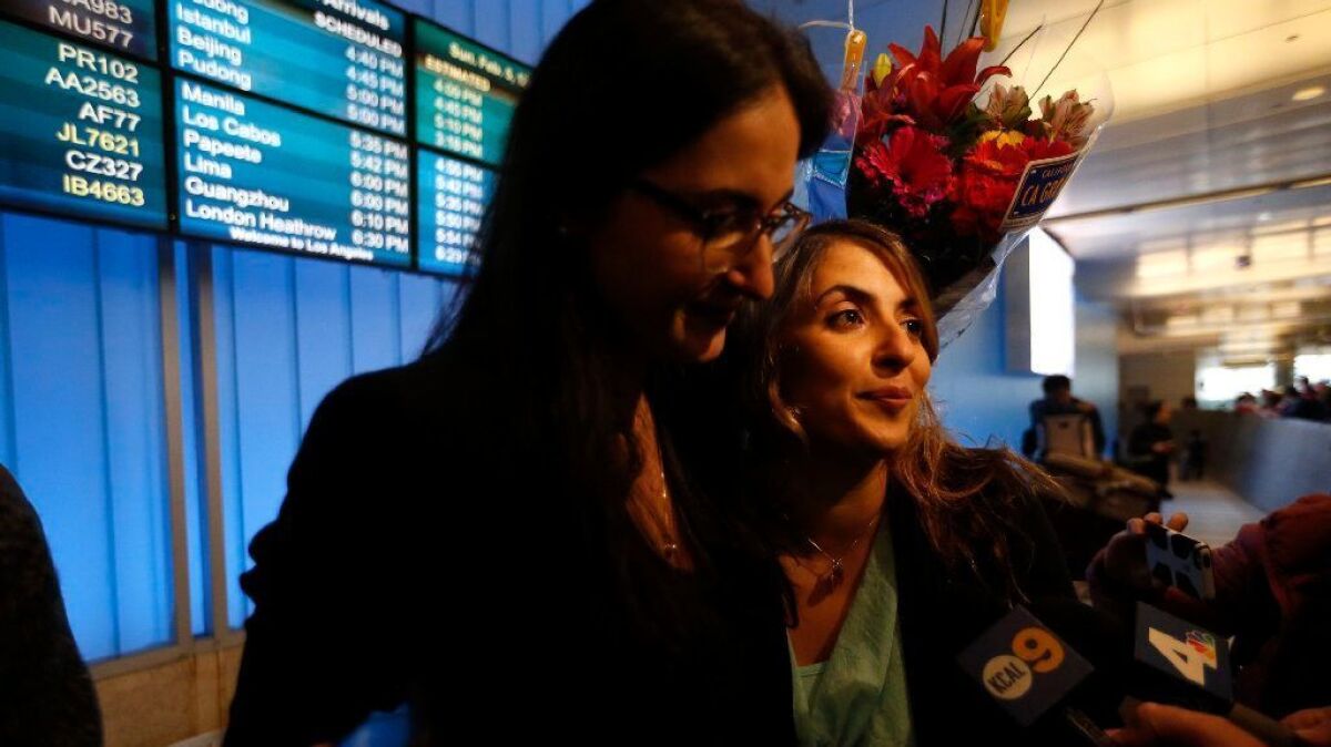 California student Sara Yarjani, right, is greeted by sister Sahar Muranovic at LAX on Sunday. Yarjani, who was born in Iran and lives in Austria, was detained at the airport earlier this week for 23 hours and deported because of President Trump's travel ban.