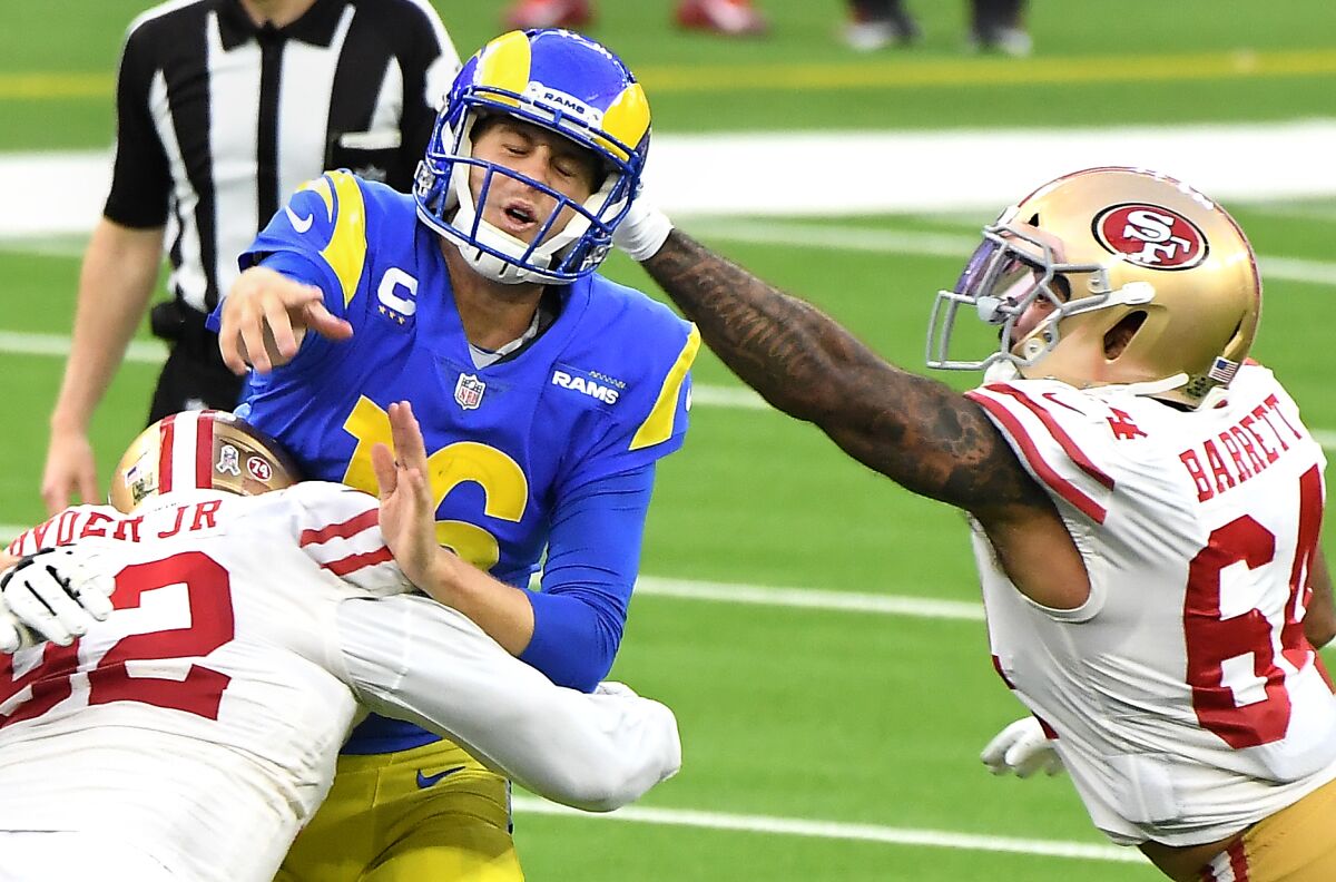 Rams quarterback Jared Goff gets off a pass under pressure from the 49ers' defense.