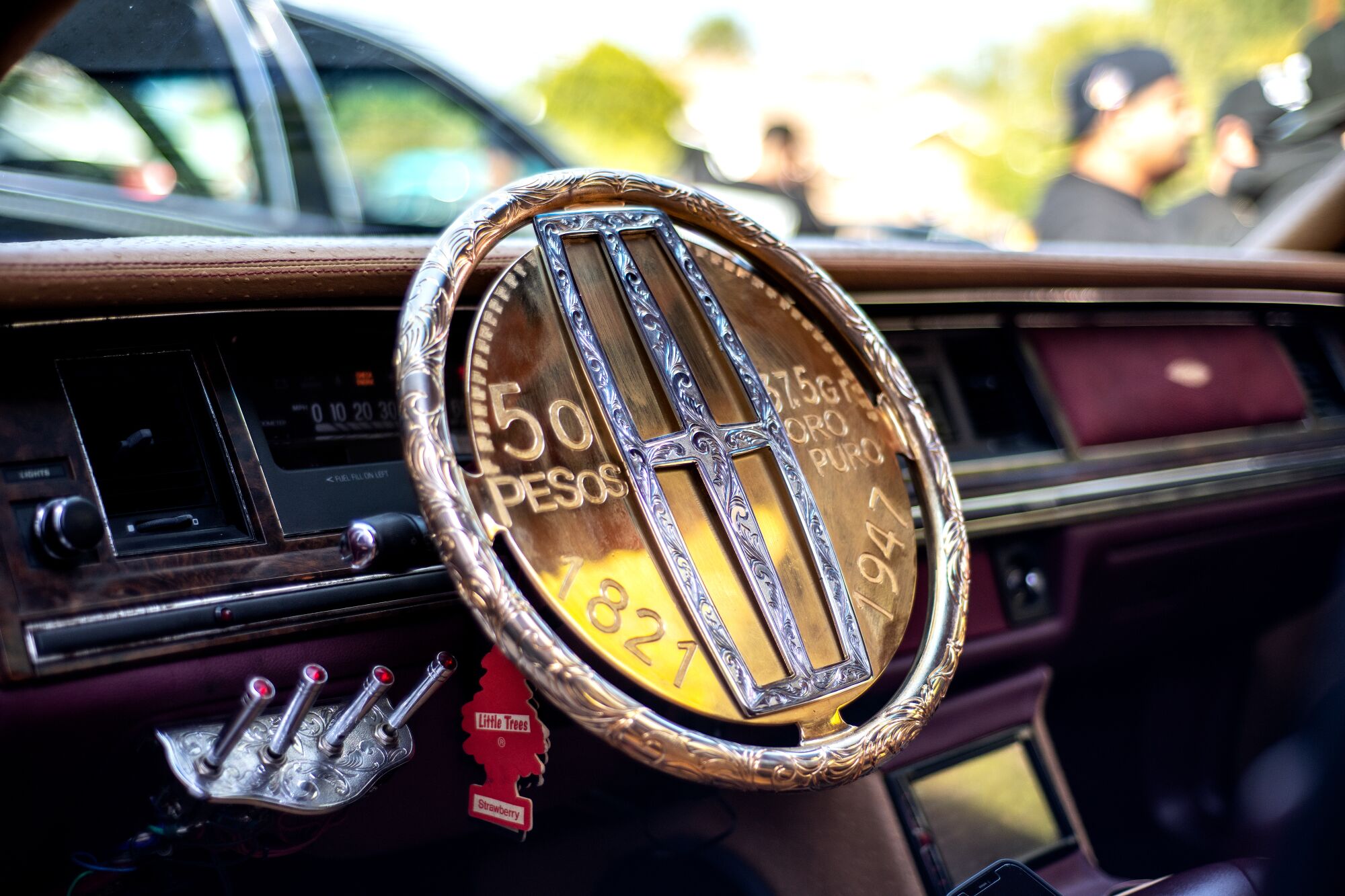 The custom gold-plated steering wheel inside Joe Arevalo's 1991 Lincoln Town Car.