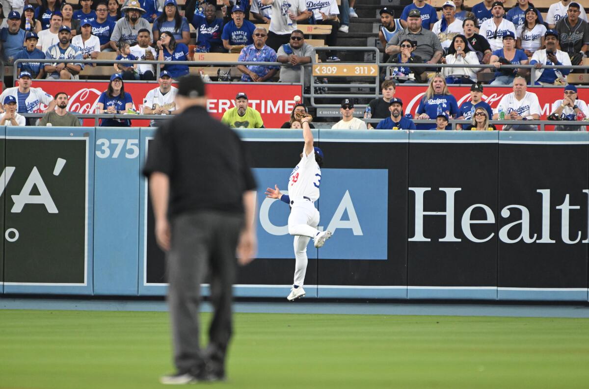 Dodgers center fielder James Outman can’t come up with a catch in the first inning of Game 1.