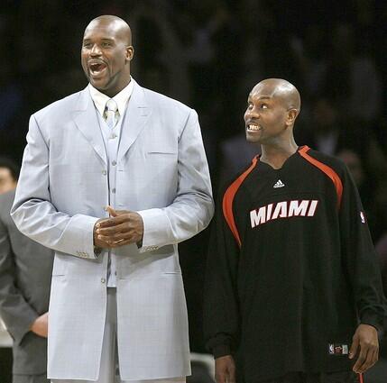 Shaquille O'Neal and Gary Payton share a laugh before the start of the game.