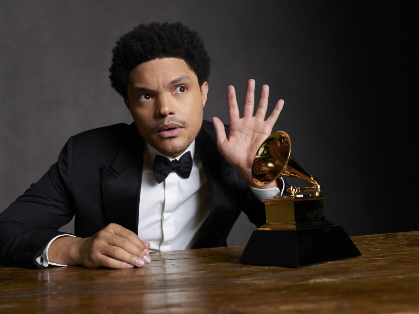 Trevor Noah shown with a Grammy statuette