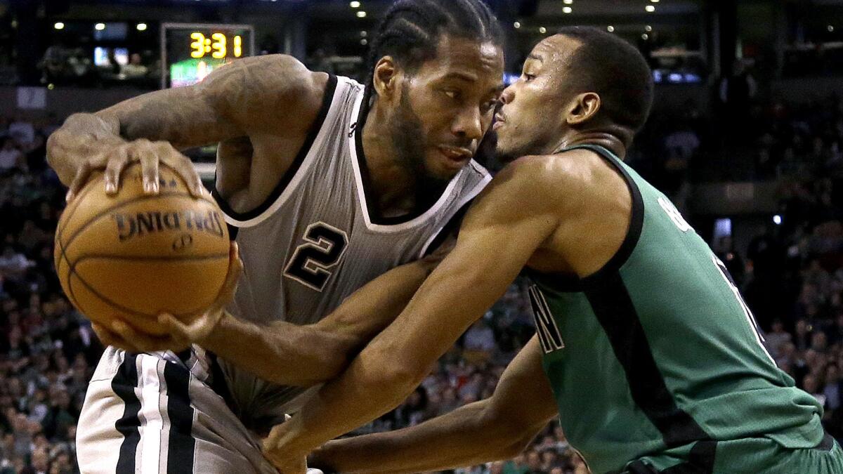 Celtics guard Avery Bradley plays tight defense against Spurs forward Kawhi Leonard during a game last season.