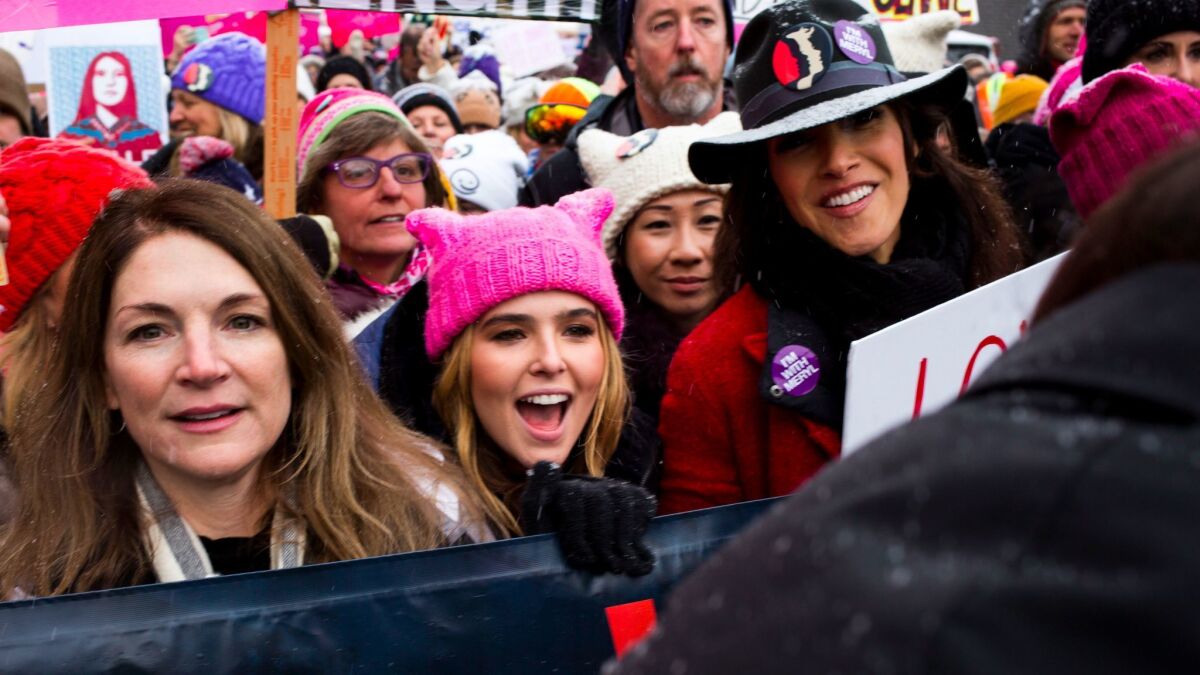 Zoey Deutch, center, and others march down Main Street during the March on Main event during the Sundance Film Festival.