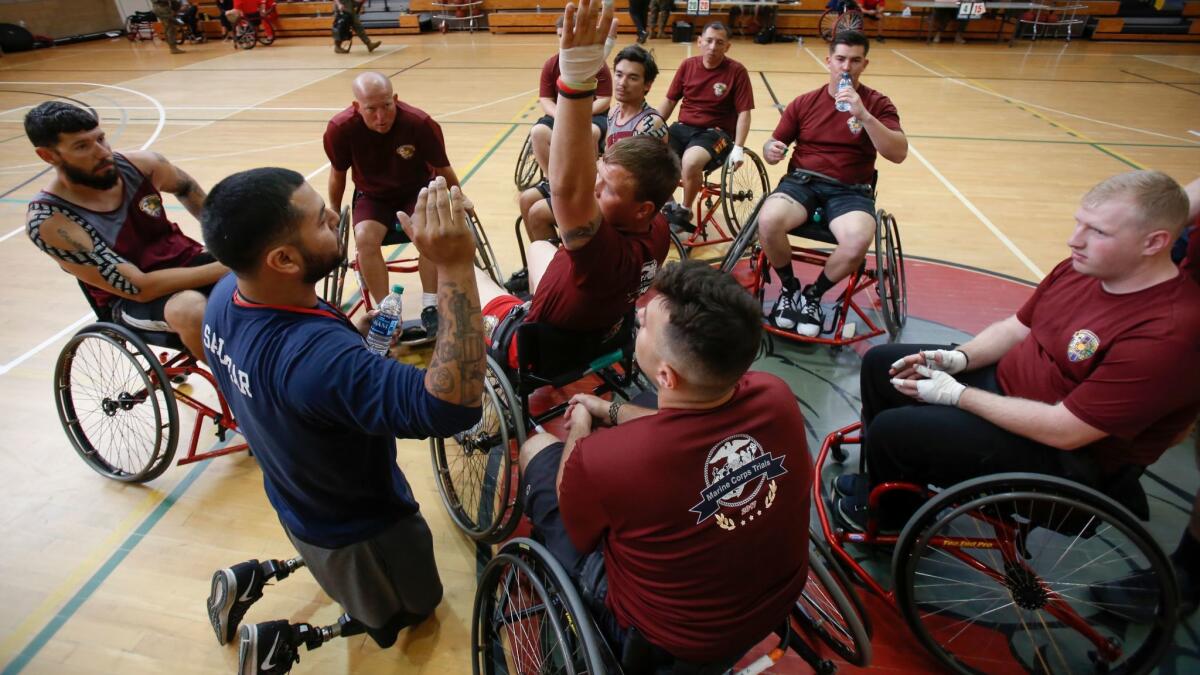 At the Marine Corps Trials at Camp Pendleton this week, Coach Salazar in the blue explains a blocking technique to the team during half-time.