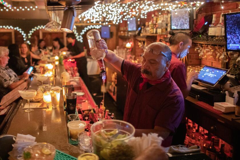 SHERMAN OAKS, CA - SEPTEMBER 09: Bartender Carlos Paredes makes drinks at the lively bar at Casa Vega in Sherman Oaks. Photographed on Friday, Sept. 9, 2022 in Sherman Oaks, CA. (Myung J. Chun / Los Angeles Times)
