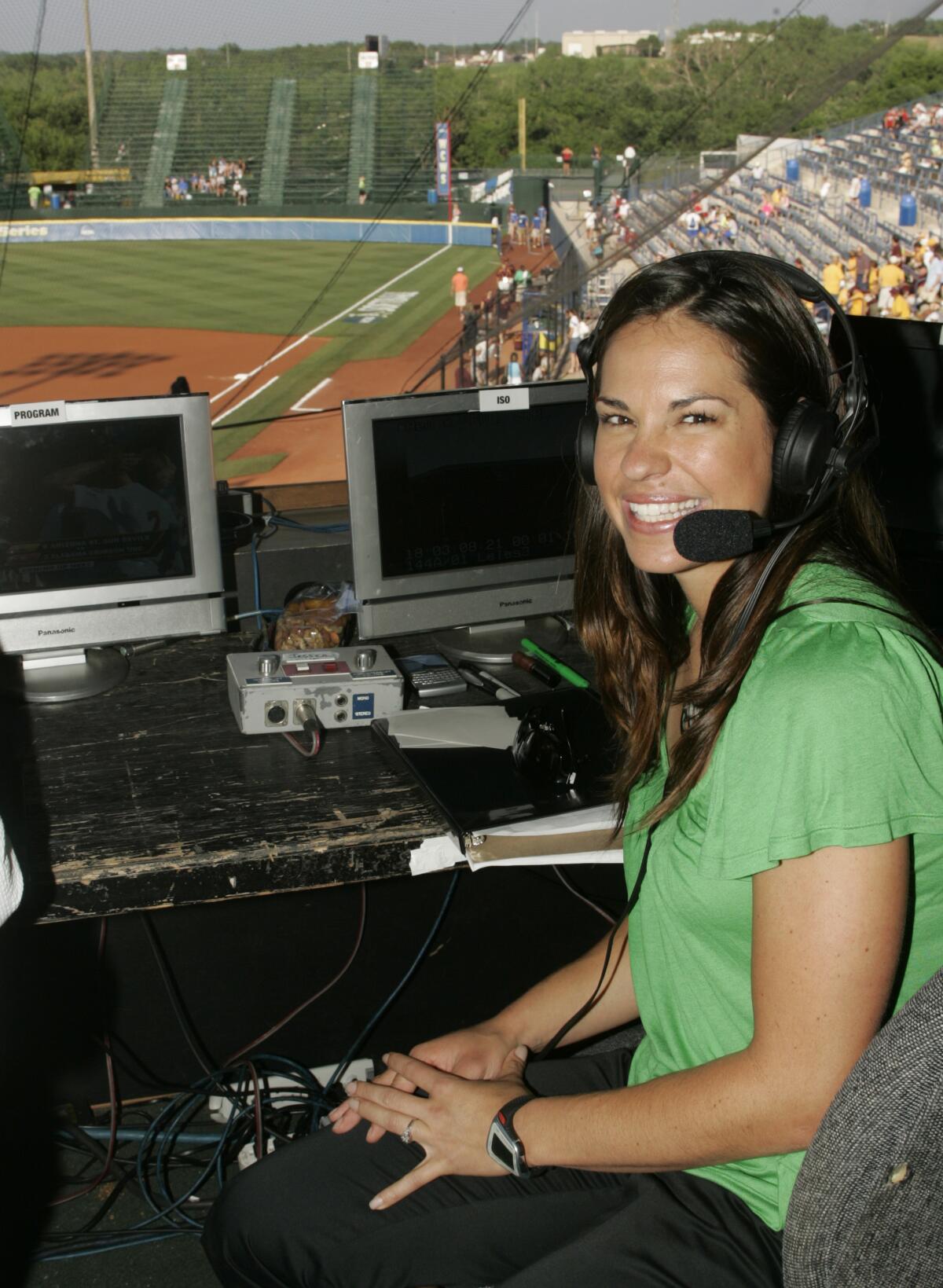 Jessica Mendoza smiles in a broadcast booth.
