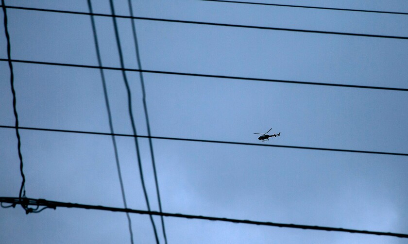 A San Diego Police Department helicopter flies over the Normal Heights neighborhood of San Diego.