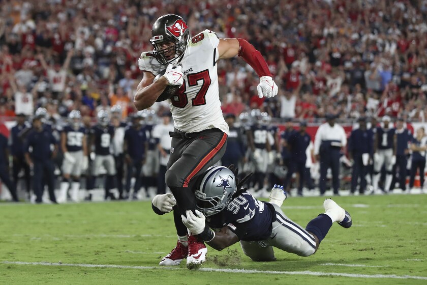 Tampa Bay Buccaneers tight end Rob Gronkowski beats Dallas Cowboys defensive end DeMarcus Lawrence.