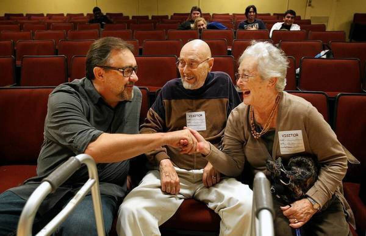 Don Hahn, left, who executive produced Disney classics including "Beauty and the Beast" and "The Lion King," chats with Robert Newman and his wife, Tomi, at Bellflower High School. Alumni of the school are helping to raise money for the school's arts programs.