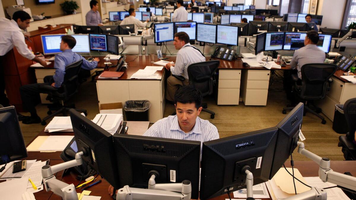 Traders at work in the downtown Los Angeles office of TCW in 2011.