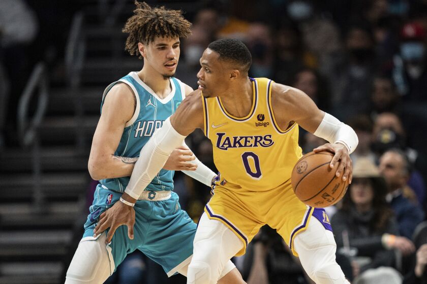 The Lakers' Russell Westbrook handles the ball against the Hornets' LaMelo Ball on Jan. 28, 2022.