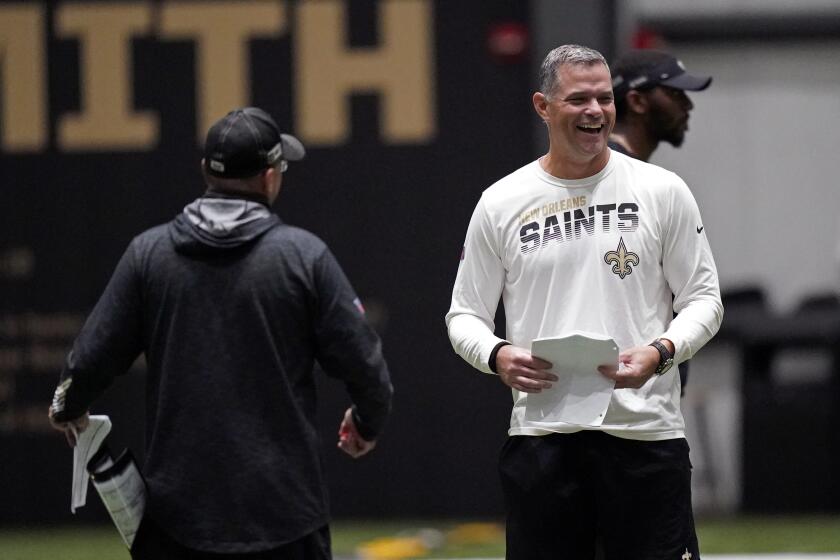 New Orleans Saints quarterbacks coach Joe Lombardi, right, laughs with offensive coordinator Pete Carmichael 