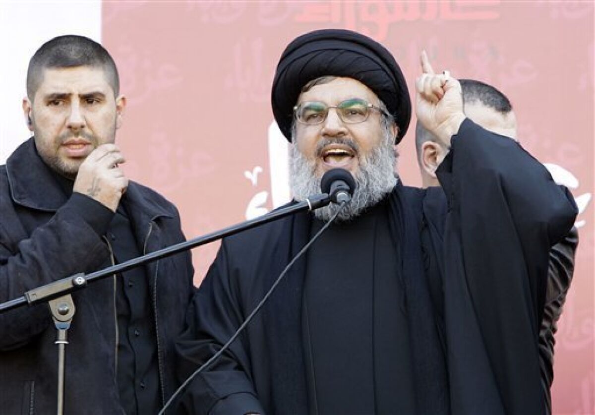 Hezbollah leader Sheik Hassan Nasrallah speaks to the crowd in a rare public appearance during a rally to mark the Muslim holy day of Ashoura, in the Hezbollah stronghold of south Beirut, Lebanon, on Tuesday Dec. 6, 2011. Sheik Hassan Nasrallah has rarely been seen in public since his Shiite Muslim group battled Israel in a monthlong war in 2006, fearing Israeli assassination. Since then, he has communicated with his followers and gives news conference mostly via satellite link. Ashoura marks the anniversary of the death in the seventh century of the Prophet Muhammad's grandson Imam Hussein. His death in a battle outside of the Iraqi city of Karbala sealed Islam's historical Sunni-Shiite split, which still bedevils the Middle East. Ashoura is one of the holiest days of the Muslim Shiite calendar. (AP Photo/Bilal Hussein)