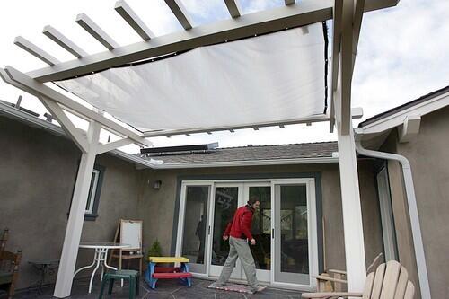 A retractable cover can shade the patio and the living room on hot days.