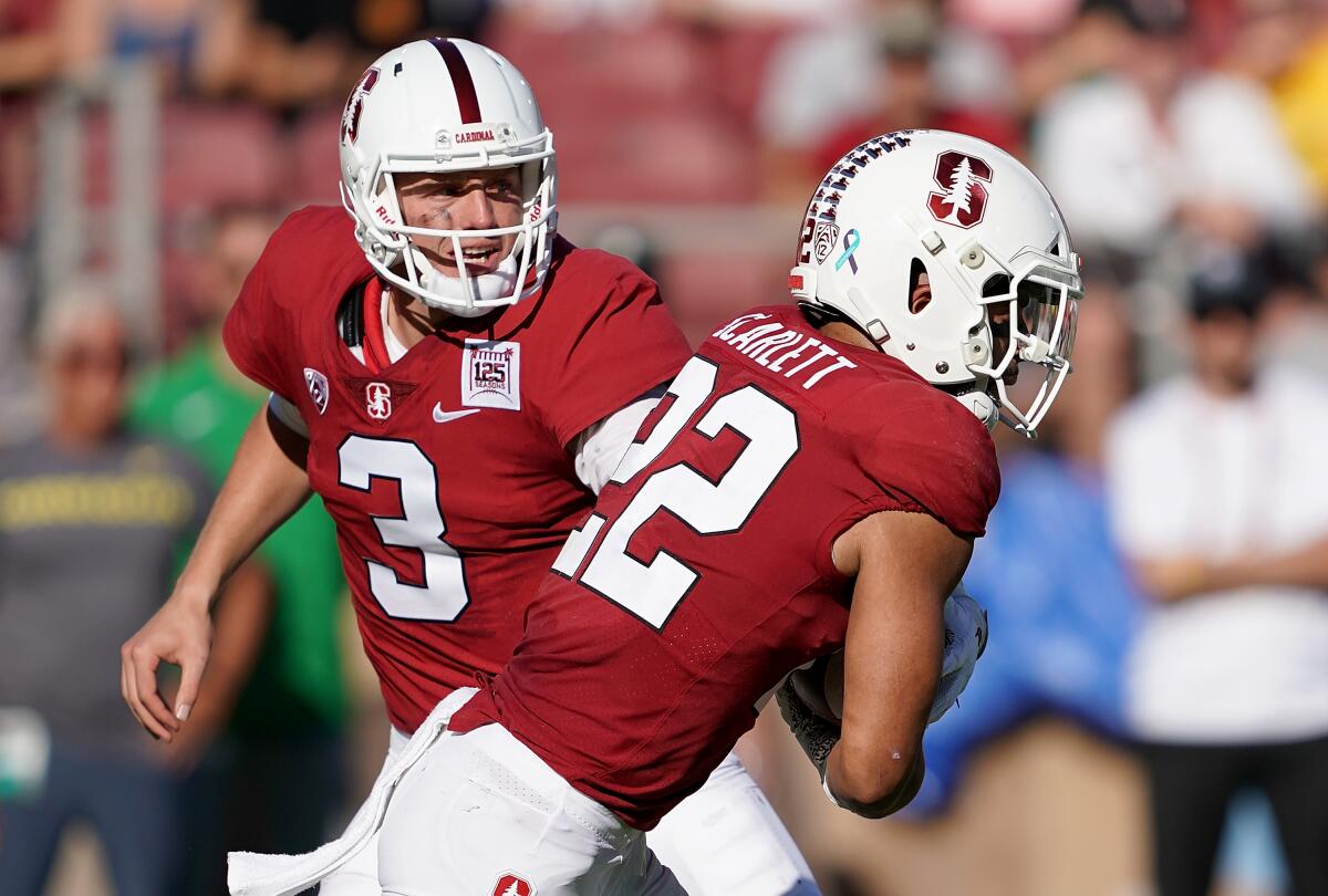Stanford quarterback K.J. Costello (3) hands off to running back Cameron Scarlett (22) against Oregon during the second quarter on Sept. 21 in Palo Alto.