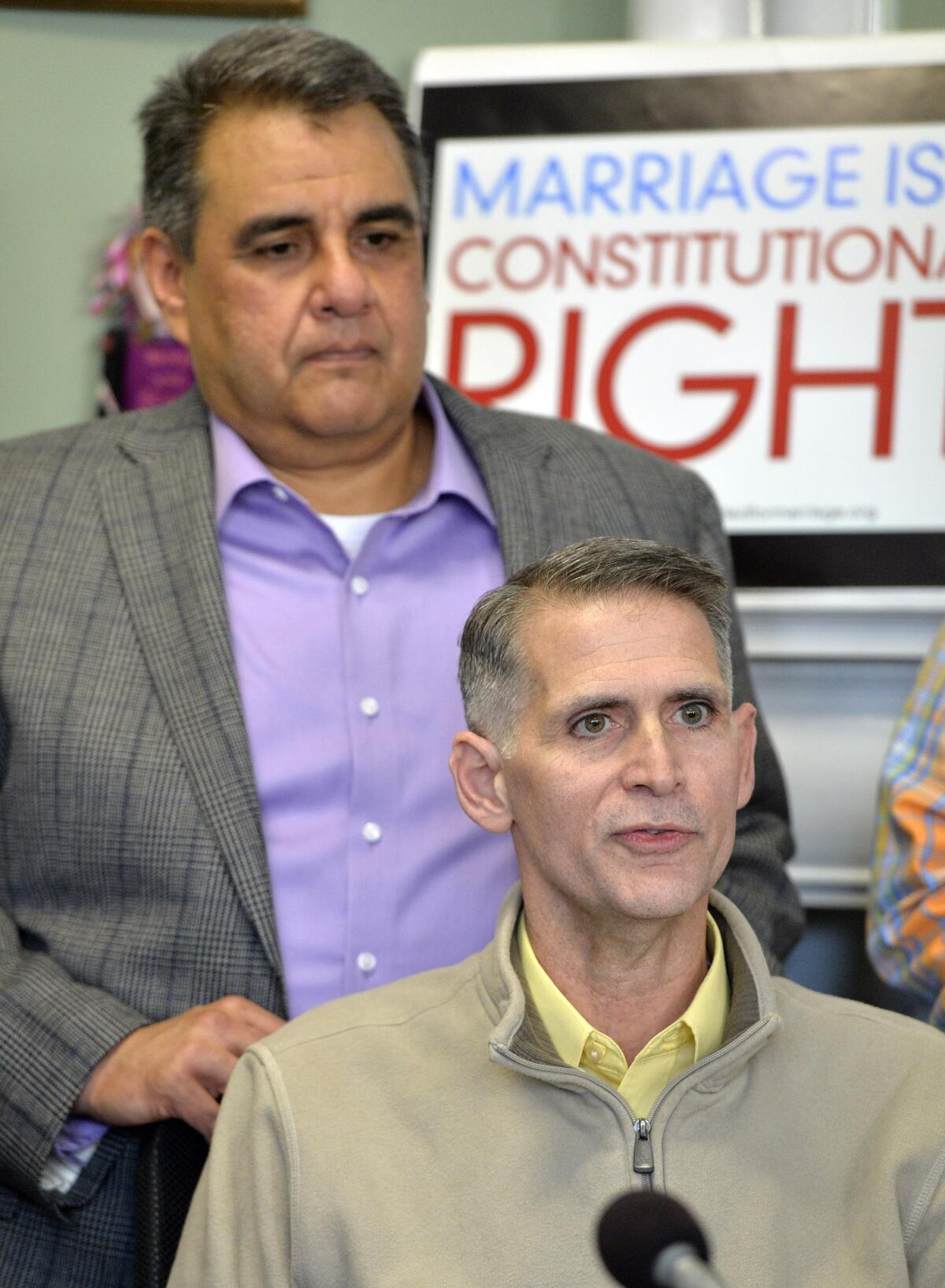 Greg Bourke, front, and his partner Michael Deleon speak to reporters following the ruling by U.S. District Judge John G. Heyburn earlier this month that Kentucky must recognize same-sex marriages performed in other states. On Thursday, Heyburn issued a final order reinforcing his ruling and didn't address a request by the state for a state.