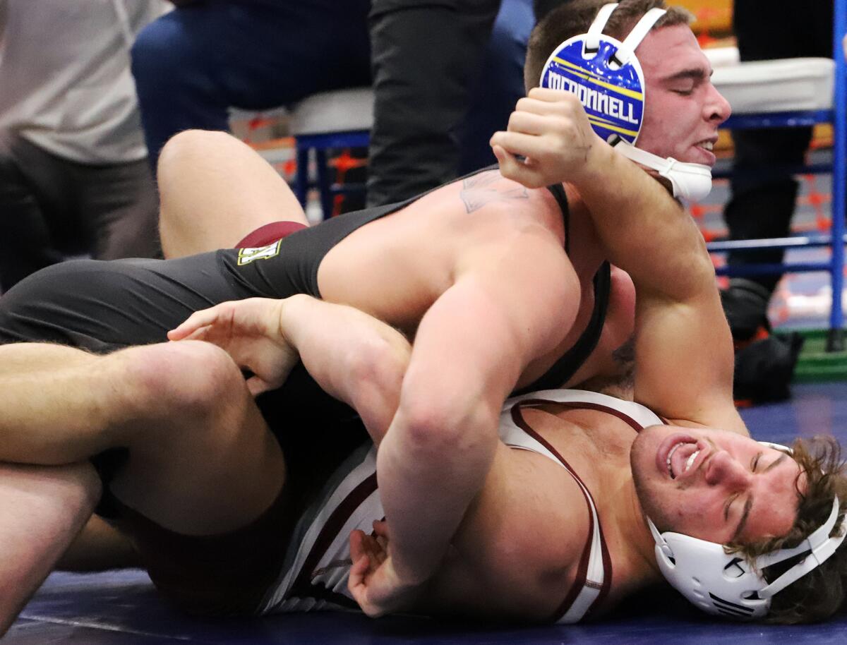 Fountain Valley's TJ McDonnell, left, and Laguna Beach's Jeremy Kanter wrestle in the 182-pound final on Saturday.