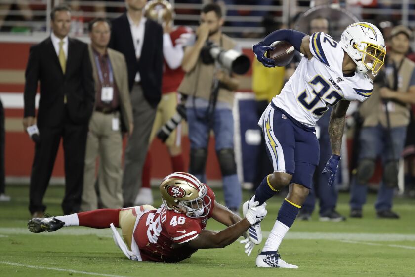 Los Angeles Chargers defensive back Nasir Adderley (32) intercepts a pass in front of San Francisco 49ers' Tyree Mayfield during the second half of an NFL preseason football game in Santa Clara, Calif., Thursday, Aug. 29, 2019. (AP Photo/Ben Margot)