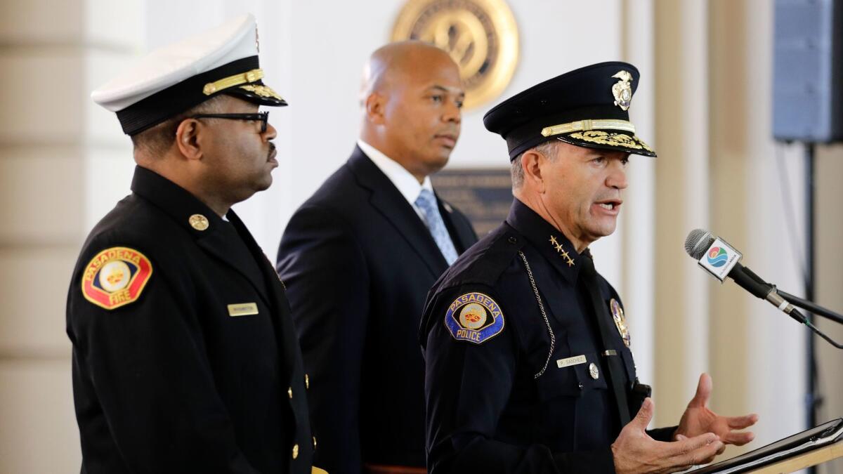 Pasadena Police Chief Phillip L. Sanchez, right, speaks on Dec. 28, 2016, about safety issues at the Rose Parade. He is joined by Pasadena Fire Chief Bertral Washington, left, and Rob Savage, special agent in charge of the U.S. Secret Service.