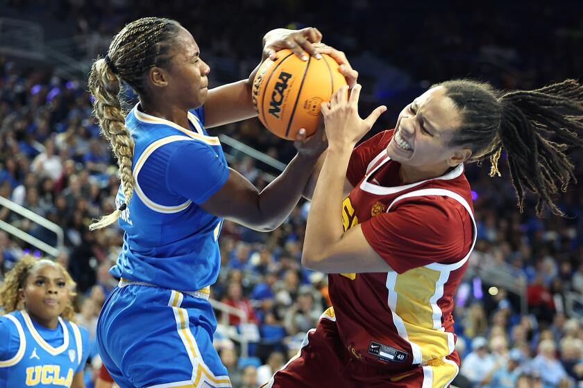 LOS ANGELES-CA-DECEMBER 30, 2023: USC's McKenzie Forbes, right, fights for the ball.