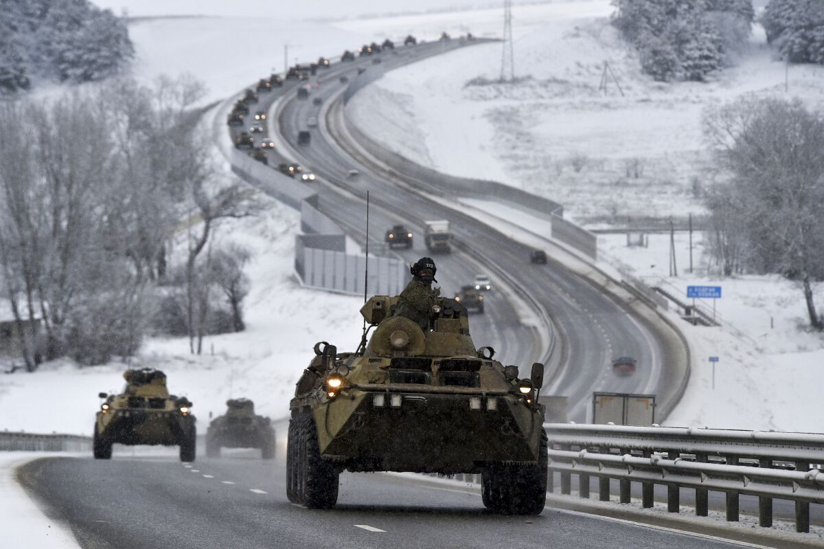 A convoy of Russian armored vehicles moves along a highway in Crimea.