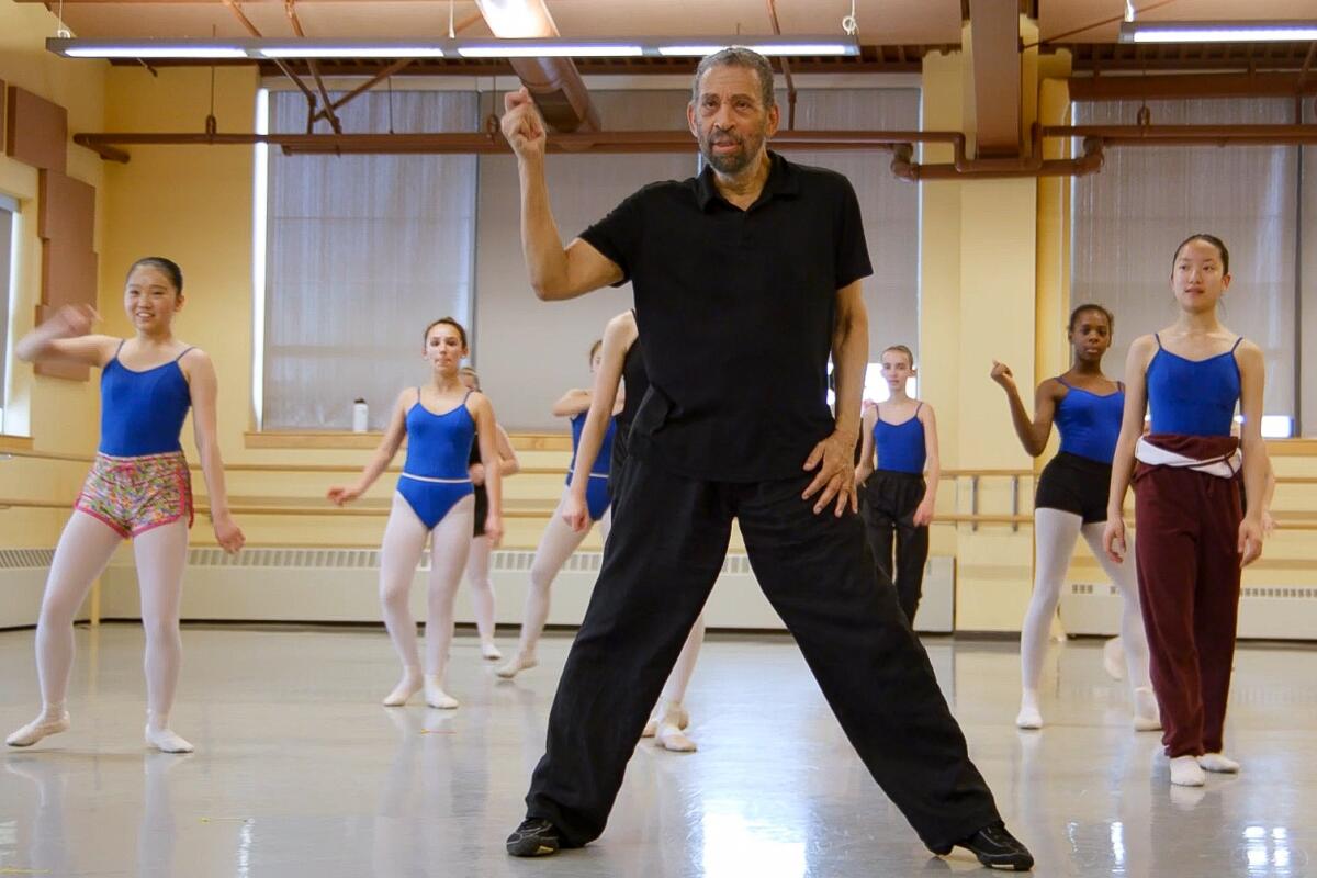 An older Maurice Hines demonstrates a dance step to young girls in a class.