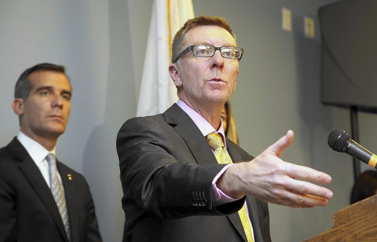 Los Angeles Schools Supt. John Deasy speaks during a news conference as Mayor Eric Garcetti, left, looks on.