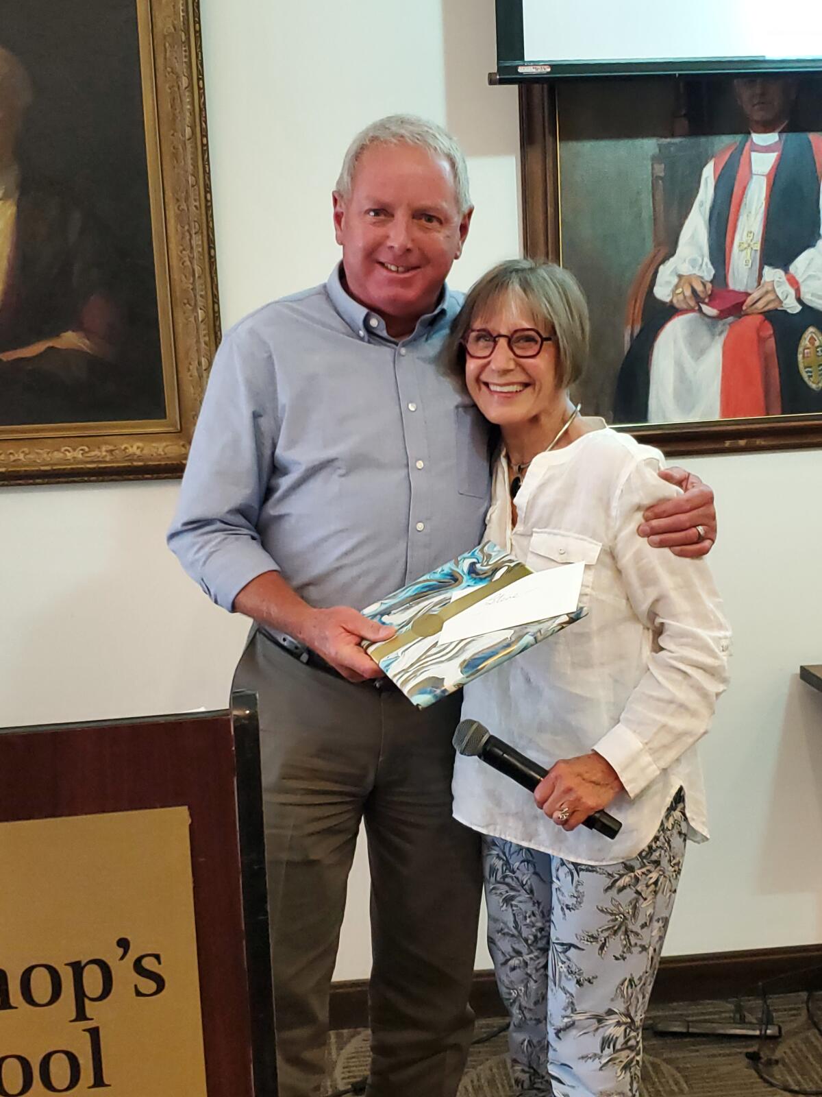 Steve Hadley receives a retirement gift from the La Jolla Community Planning Association from trustee Diane Kane.