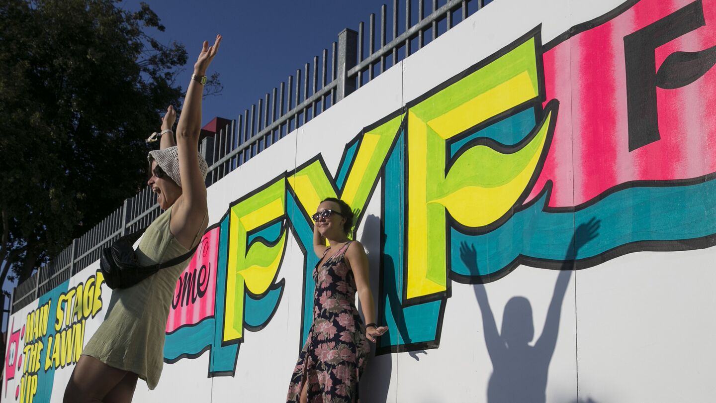 Markica Schulman, left, and Erin Savino stop for a photo as they enter Exposition Park for the three-day FYF Fest.