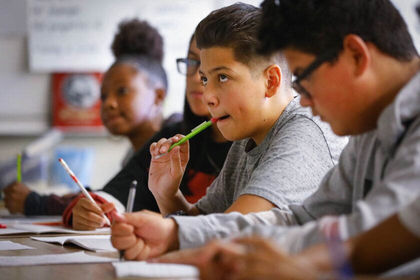 Howard Lipin  U-T Eighth-grade student Domanick Castro (center) and his classmates participate in Glenn Lloyd’s class at Wilson Middle School.
