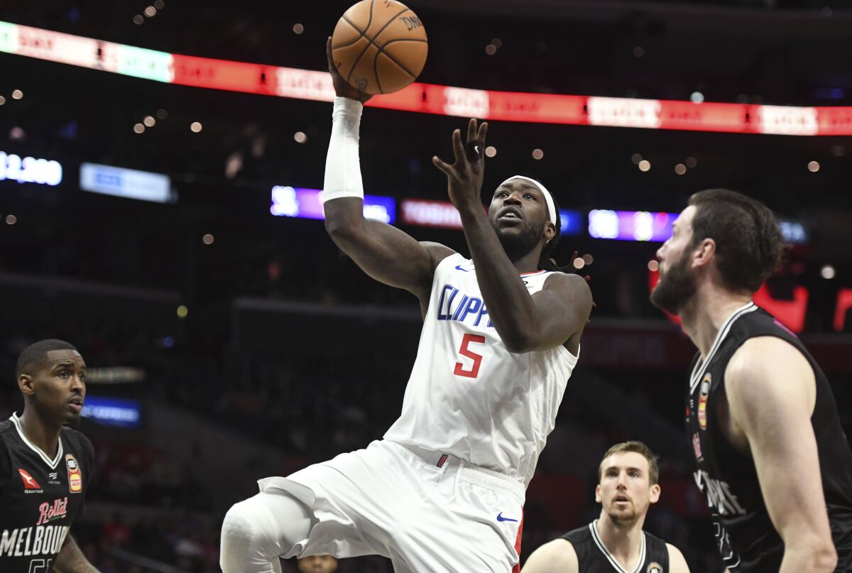 Clippers center Montrezl Harrell drives down the lane for a layup during a preseason game against Melbourne on Sunday.