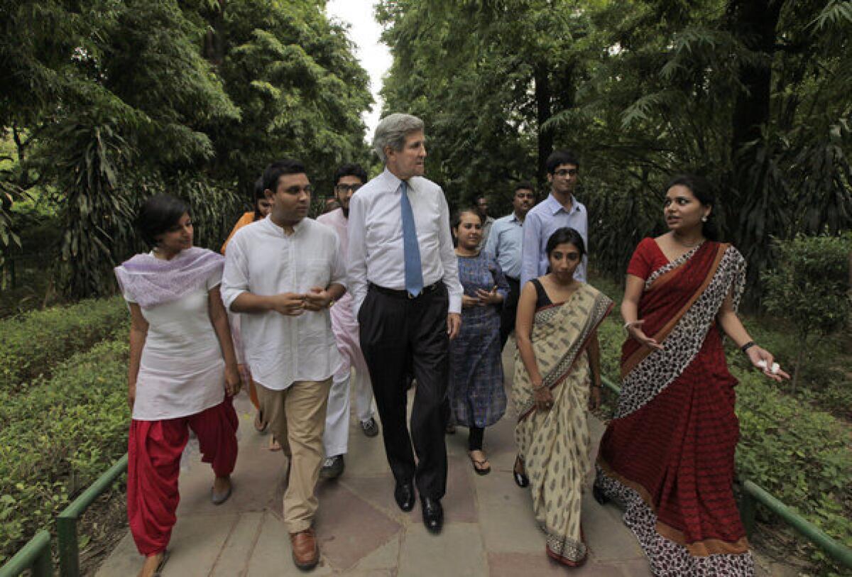 U.S. Secretary of State John Kerry, center, meets with young alumni of State Department programs during their walk at Lodhi gardens, in New Delhi on Monday.