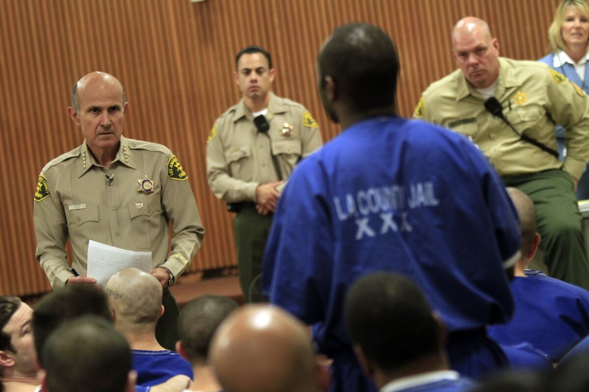 Lee Baca, left, meets with inmates to listen to their complaints at Men's Central Jail when he was L.A. County sheriff in 2011. (Irfan Khan / Los Angeles Times)