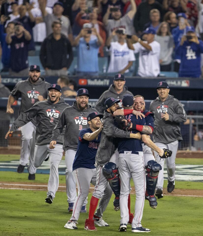 Red Sox players celebrate beating the Dodgers 5-1 and winning game five and the World Series.