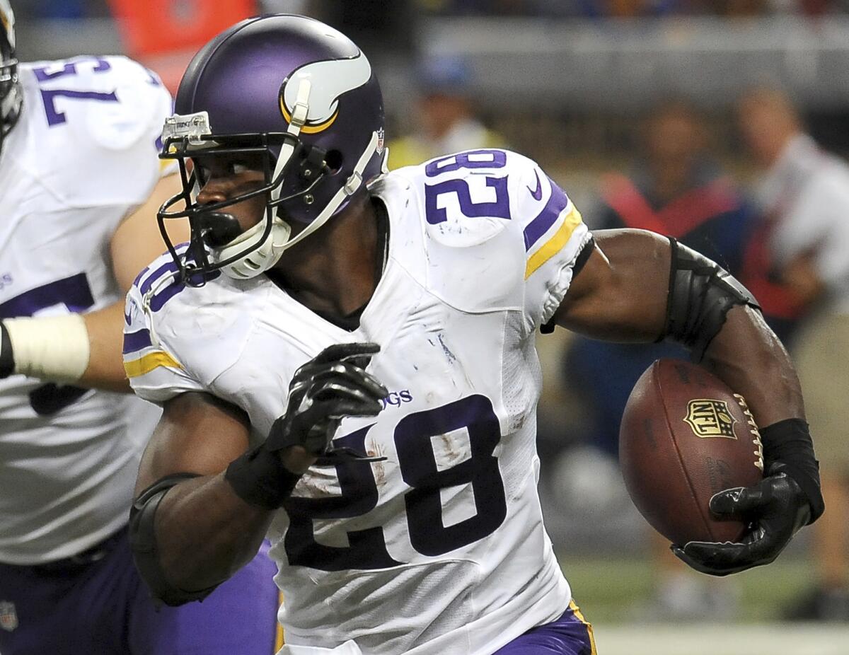 Vikings running back Adrian Peterson carries the ball against the St. Louis Rams during a Sept. 7 game in St. Louis.